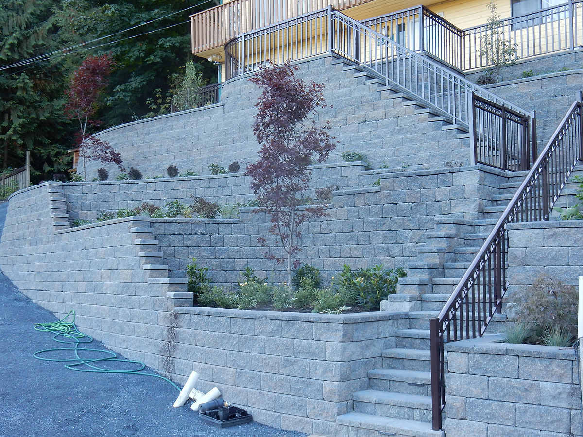 Multi-tier Allan Block retaining wall with stairs by Deerwood Landscaping