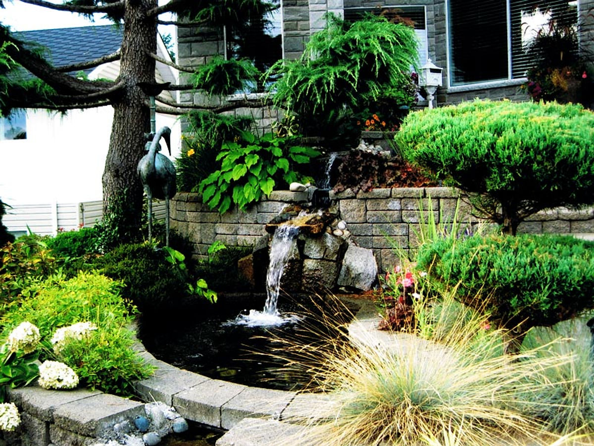 Residential waterfall and pond by Deerwood Landscaping, North Vancouver